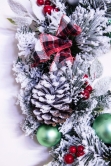 50cm Flocked Decorated Mixed Pine Wreath with Tartan Bows