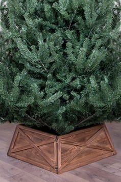 Christmas tree with brown wooden tree skirt