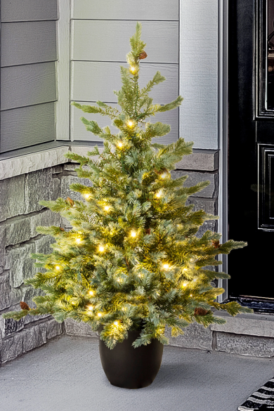 Artificial christmas tree in outlet pot