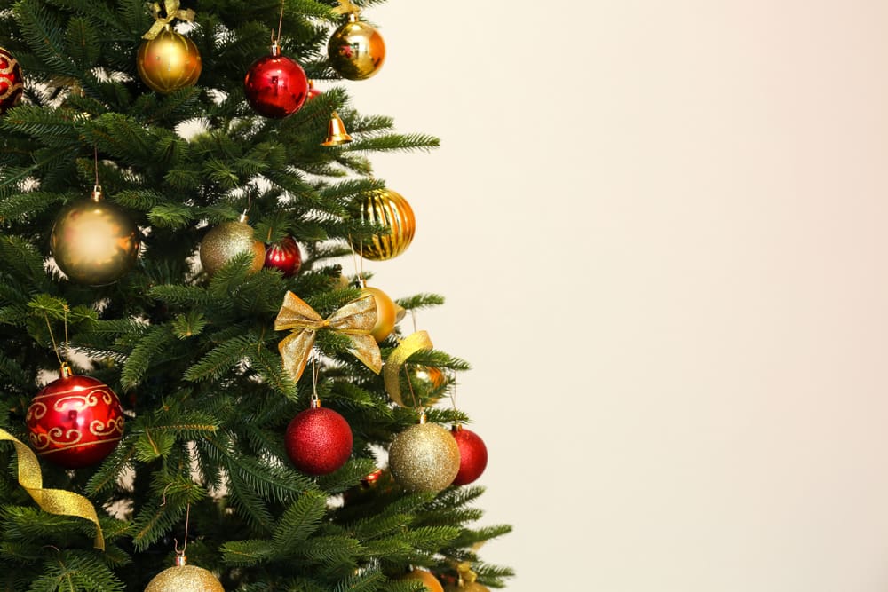 Decorated Christmas tree on light background