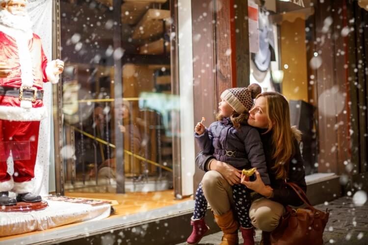 Mother and daughter looking at a Christmas window display