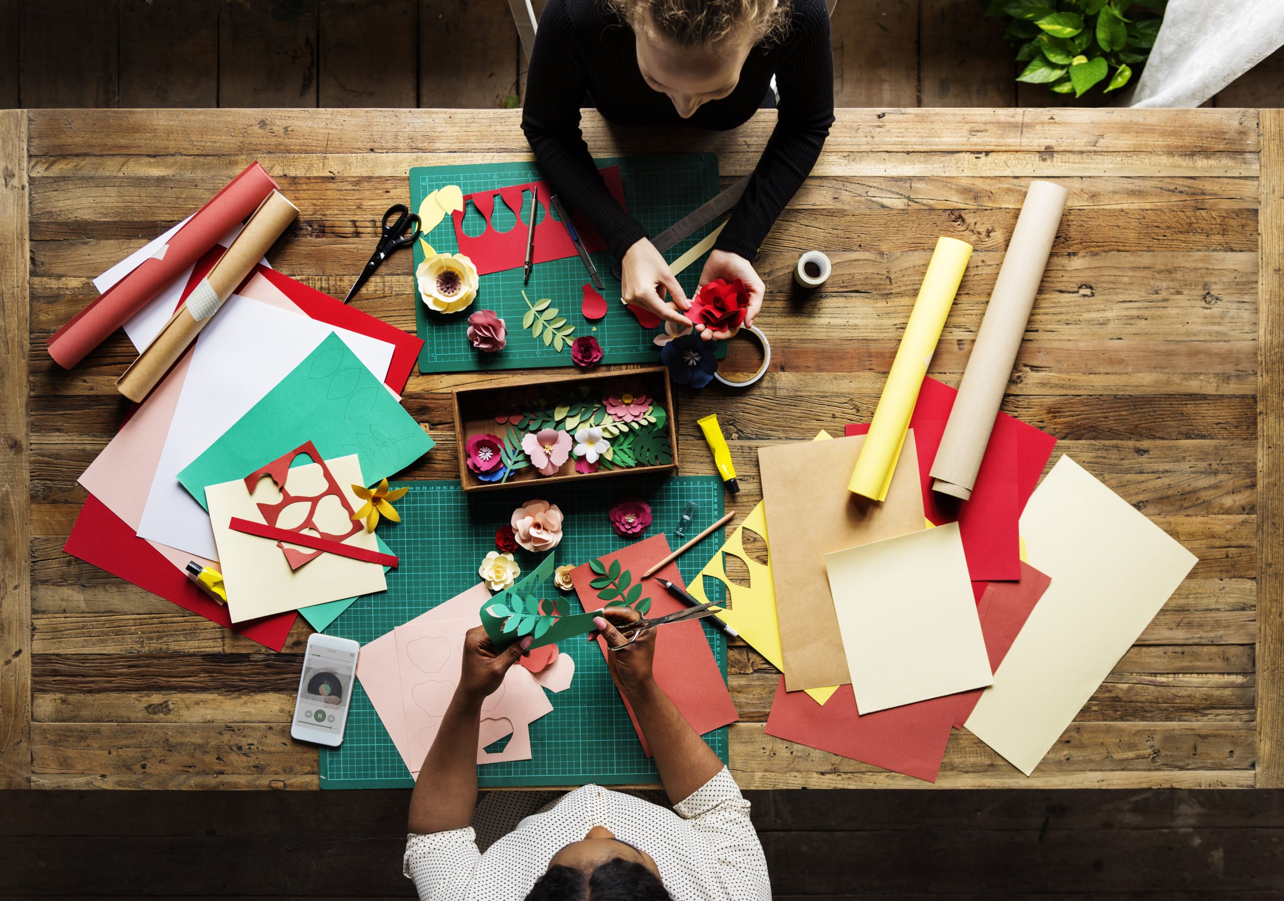 two people doing crafts at a table