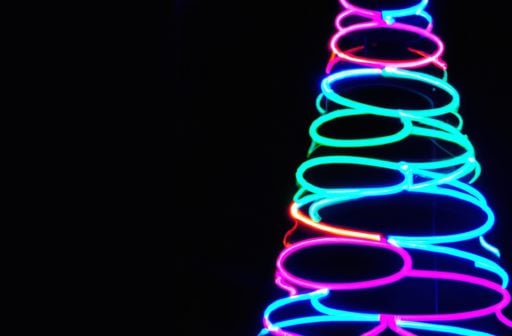 Cicular neon LED lights cascading downward ranging in size to form a Christmas tree